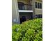 View of building with large bush in the foreground at 4037 Crockers Lake Blvd # 14, Sarasota, FL 34238
