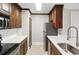 Galley kitchen features stainless appliances, beautiful wood cabinets and white quartz countertops at 4037 Crockers Lake Blvd # 14, Sarasota, FL 34238