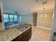 The kitchen opens to the living and dining areas, offering stainless steel appliances, granite counters, and stylish pendant lighting at 4037 Crockers Lake Blvd # 14, Sarasota, FL 34238