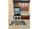 This home showcases a stainless steel sink, granite counters, and well-maintained appliances and dark cabinetry at 4037 Crockers Lake Blvd # 14, Sarasota, FL 34238
