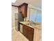 This kitchen features stainless steel appliances, granite counters, tile flooring, and dark wood cabinets at 4037 Crockers Lake Blvd # 14, Sarasota, FL 34238