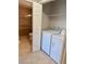 Laundry room with tile floor, full size washer and dryer, and access to bathroom at 4037 Crockers Lake Blvd # 14, Sarasota, FL 34238