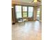 Bright living space with tiled floors, large windows, and sheer curtains create a welcoming and airy atmosphere at 4037 Crockers Lake Blvd # 14, Sarasota, FL 34238