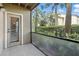 Private screened-in patio with views of lush tropical landscaping at 4037 Crockers Lake Blvd # 14, Sarasota, FL 34238