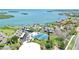 Panoramic aerial view of a waterfront community featuring tennis courts, pool, docks and lush landscaping at 4234 Gulf Of Mexico Dr # G2, Longboat Key, FL 34228