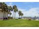 Beautiful backyard features tropical landscaping, manicured lawn, and a private dock at 4234 Gulf Of Mexico Dr # G2, Longboat Key, FL 34228
