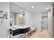Bright bathroom featuring a vessel sink, large mirror, and linen closet at 4234 Gulf Of Mexico Dr # G2, Longboat Key, FL 34228