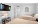 Bedroom with 2 twin beds, neutral walls, and a television at 4234 Gulf Of Mexico Dr # G2, Longboat Key, FL 34228