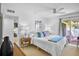 Bright bedroom features neutral walls, ceiling fan, ensuite bath, and balcony access at 4234 Gulf Of Mexico Dr # G2, Longboat Key, FL 34228