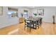 Elegant dining room with seating for eight and waterfront views at 4234 Gulf Of Mexico Dr # G2, Longboat Key, FL 34228
