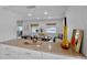 Open-concept living area featuring a dining room with waterfront views and a table for six at 4234 Gulf Of Mexico Dr # G2, Longboat Key, FL 34228