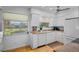 Bright, white kitchen with granite countertops and a view of the community pond at 4234 Gulf Of Mexico Dr # G2, Longboat Key, FL 34228