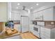 Modern kitchen with white appliances, granite countertops, and ample cabinet space at 4234 Gulf Of Mexico Dr # G2, Longboat Key, FL 34228