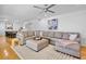Comfortable living room featuring stylish decor, a large sectional sofa, and wood floors at 4234 Gulf Of Mexico Dr # G2, Longboat Key, FL 34228