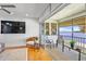 Bright living room with sliding glass doors leading to a screened lanai at 4234 Gulf Of Mexico Dr # G2, Longboat Key, FL 34228