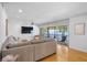 Cozy living room with water views and a sliding glass door to the screened patio at 4234 Gulf Of Mexico Dr # G2, Longboat Key, FL 34228