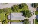 Aerial view of the house showcasing a screened-in lanai surrounded by trees and green lawn at 4402 Natures Reach Ter, Parrish, FL 34219