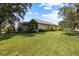 Well-manicured backyard features a plush green lawn and mature trees at 4402 Natures Reach Ter, Parrish, FL 34219
