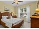 Bedroom with wood furniture, ceiling fan, and large window at 4402 Natures Reach Ter, Parrish, FL 34219