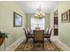Charming dining room with chandelier, window with blinds, and seating for six at 4402 Natures Reach Ter, Parrish, FL 34219