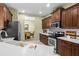 Bright kitchen with stainless steel appliances, white countertops, and dark wood cabinets at 4402 Natures Reach Ter, Parrish, FL 34219