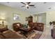 Cozy living room with a ceiling fan and tan walls, featuring leather furniture at 4402 Natures Reach Ter, Parrish, FL 34219
