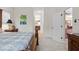 Bedroom featuring a detailed wood bed frame and a view of the hall with an en-suite bathroom at 4402 Natures Reach Ter, Parrish, FL 34219