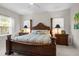 Spacious main bedroom featuring a four-poster bed, neutral tones, and plenty of natural light at 4402 Natures Reach Ter, Parrish, FL 34219
