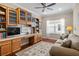 Cozy office space with built-in shelves, desk, window, and comfortable sofa at 4402 Natures Reach Ter, Parrish, FL 34219