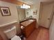 Bathroom with vanity, granite counters, decorative mirror, and earth-toned tile flooring at 4607 W North B St # 105, Tampa, FL 33609
