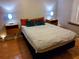 Bedroom features a queen-size bed with floating nightstands and tiled flooring at 4607 W North B St # 105, Tampa, FL 33609