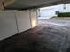 View of the carport area with white fencing and partial building visibility at 4607 W North B St # 105, Tampa, FL 33609