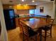 Functional kitchen featuring a breakfast bar with cooktop and dark countertops at 4607 W North B St # 105, Tampa, FL 33609