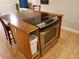 Kitchen island with a cooktop, oven, and storage at 4607 W North B St # 105, Tampa, FL 33609