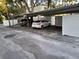 Assigned covered parking area with cars parked under the metal awning at 4607 W North B St # 105, Tampa, FL 33609