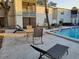 Community pool area with multiple seating options and well-maintained landscaping at 4607 W North B St # 105, Tampa, FL 33609