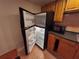 Kitchen featuring a black refrigerator, microwave, and adjacent cabinets at 4607 W North B St # 105, Tampa, FL 33609