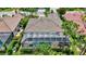 A great aerial view of the house showing the screened-in pool, well-maintained yard, and manicured landscaping at 4818 88Th E St, Bradenton, FL 34211