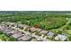 The aerial shows a neighborhood with lush green spaces, a golf course, and mature landscaping at 4818 88Th E St, Bradenton, FL 34211