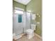 Bright bathroom featuring a glass shower and modern toilet, complemented by fresh white towels at 4818 88Th E St, Bradenton, FL 34211
