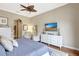 Spacious bedroom with sliding glass door, TV, and soft, natural light at 4818 88Th E St, Bradenton, FL 34211