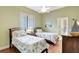 Inviting bedroom with two twin beds, ceiling fan, and a large window at 4818 88Th E St, Bradenton, FL 34211