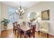 Dining room showcasing chandelier, art, buffet table and view to outside through a window with shutters at 4818 88Th E St, Bradenton, FL 34211