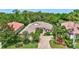 Beautiful home with a tile roof, brick driveway, well manicured lawn and landscaping, and a beautiful front entryway at 4818 88Th E St, Bradenton, FL 34211