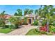 Beautiful single-story home with a tile roof, a brick driveway, and lush landscaping in the front yard at 4818 88Th E St, Bradenton, FL 34211
