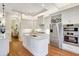 Modern kitchen with stainless steel appliances, white cabinets, and island sink at 4818 88Th E St, Bradenton, FL 34211
