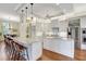 Bright kitchen with white cabinets, marble countertops, and stainless steel appliances at 4818 88Th E St, Bradenton, FL 34211