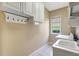 Laundry room with tiled floors, cabinets, and a utility sink at 4818 88Th E St, Bradenton, FL 34211