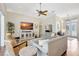 Elegant living room with large windows, comfortable seating, and a ceiling fan at 4818 88Th E St, Bradenton, FL 34211