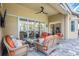Covered patio with comfortable wicker furniture, offering an ideal spot for relaxing and entertaining at 4818 88Th E St, Bradenton, FL 34211